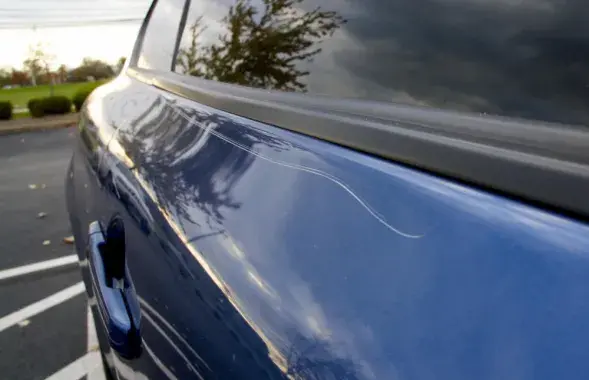 Царапина на кузове автомобиля, иллюстративное фото
