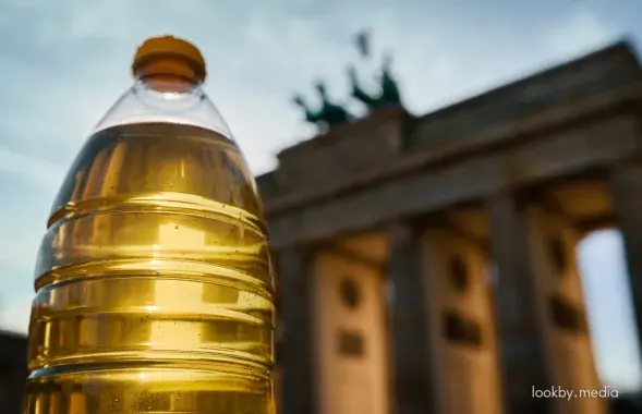 Бутылка масла на фоне Бранденбургских ворот в Берлине
